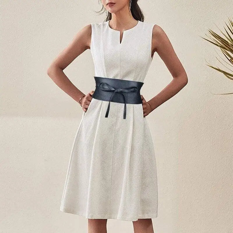 White dress paired with a velthuria belt featuring a black obi style in Leather and Faux Leather