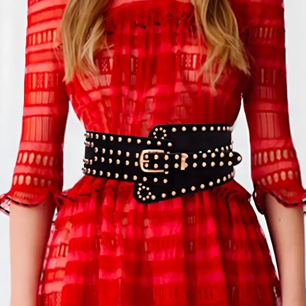 Black studded wide waist belt with silver buckle displayed for fashion accessory