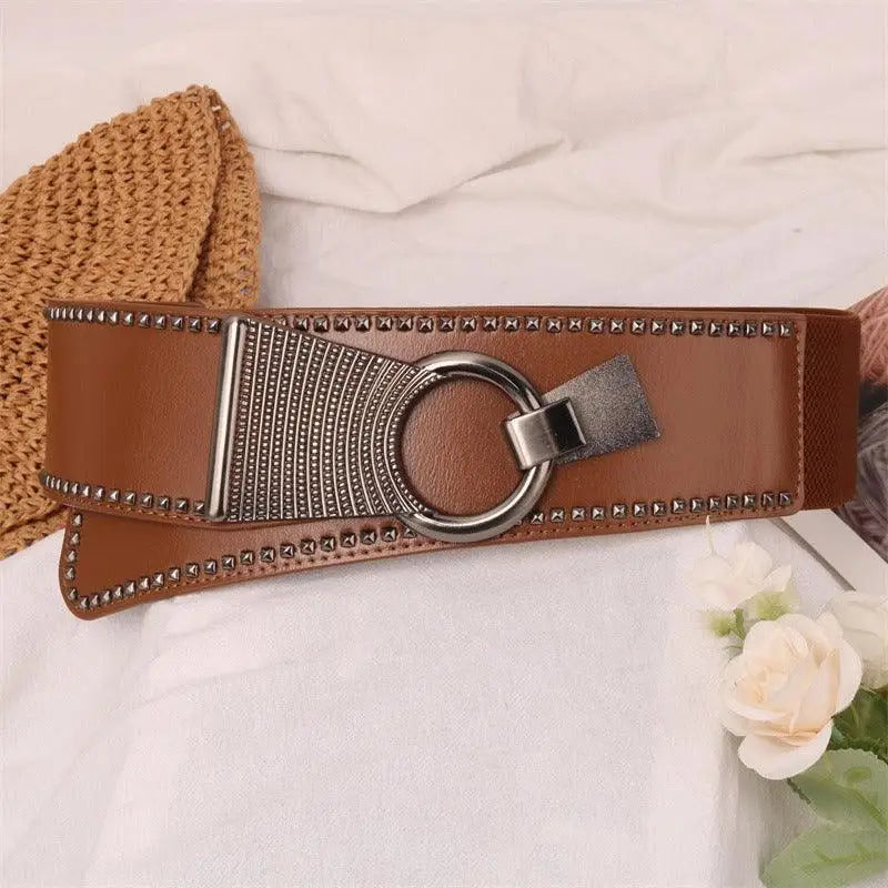 Brown studded Christia Belt with circular metal buckle for stylish leather design