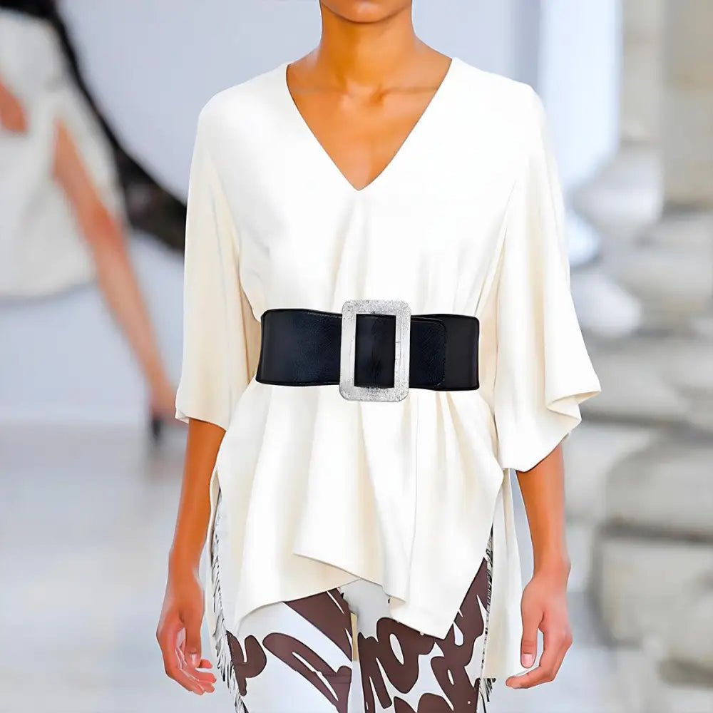 Woman’s white tunic with a wide black Eloisa belt from Satin Black Dress collection