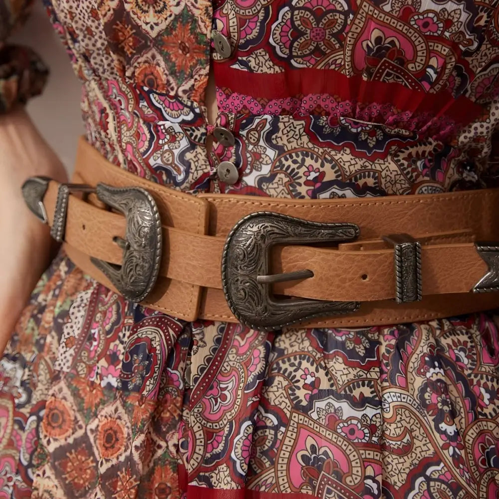 Brown leather belt with ornate silver buckles from Loretta Belt collection for bohemian style
