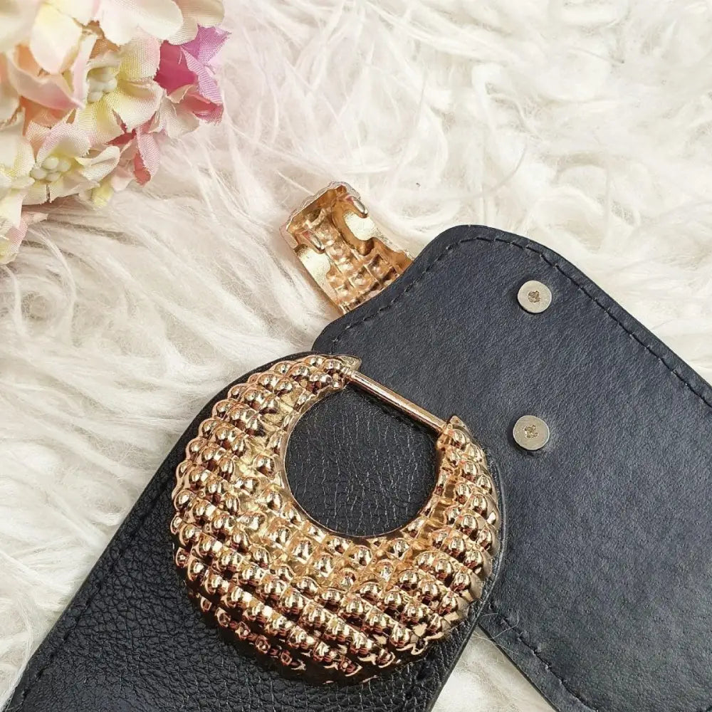 Black leather belt with textured gold buckle paired with Pink Shirt Dress