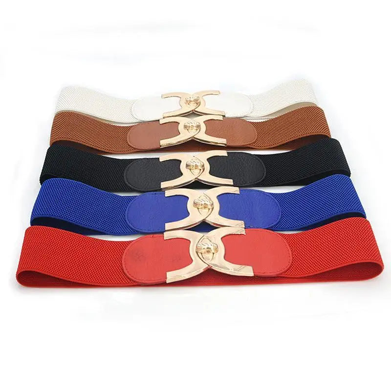 Assorted elastic waist belts with decorative buckles displayed for fashion accessories