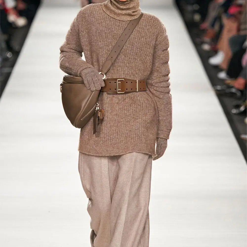 Beige turtleneck sweater with belt and bag for stylish winter fashion display