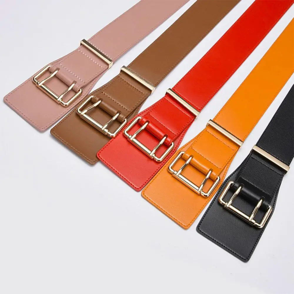 Colorful belts with gold buckles displayed with Beige Turtleneck Sweater and Bag