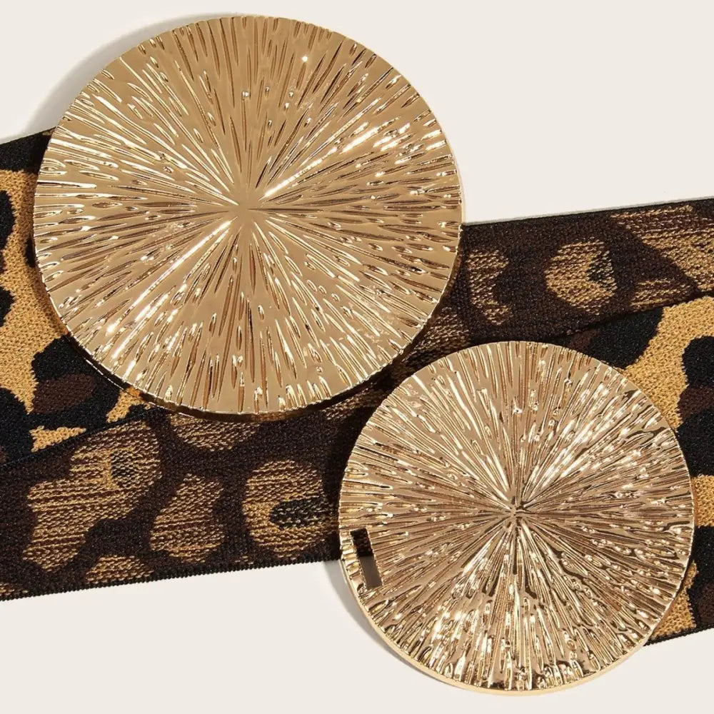 Leopolda High Belt with Leopard Print and Gold Circular Buckles on textured gold coasters