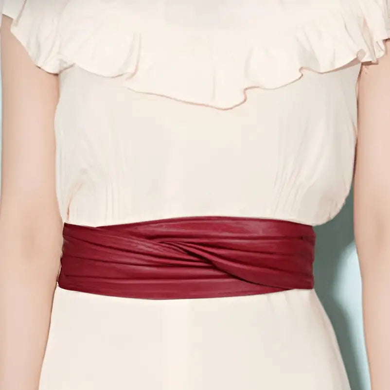 White dress with black sash and utama belt featuring Burgundy and leather details