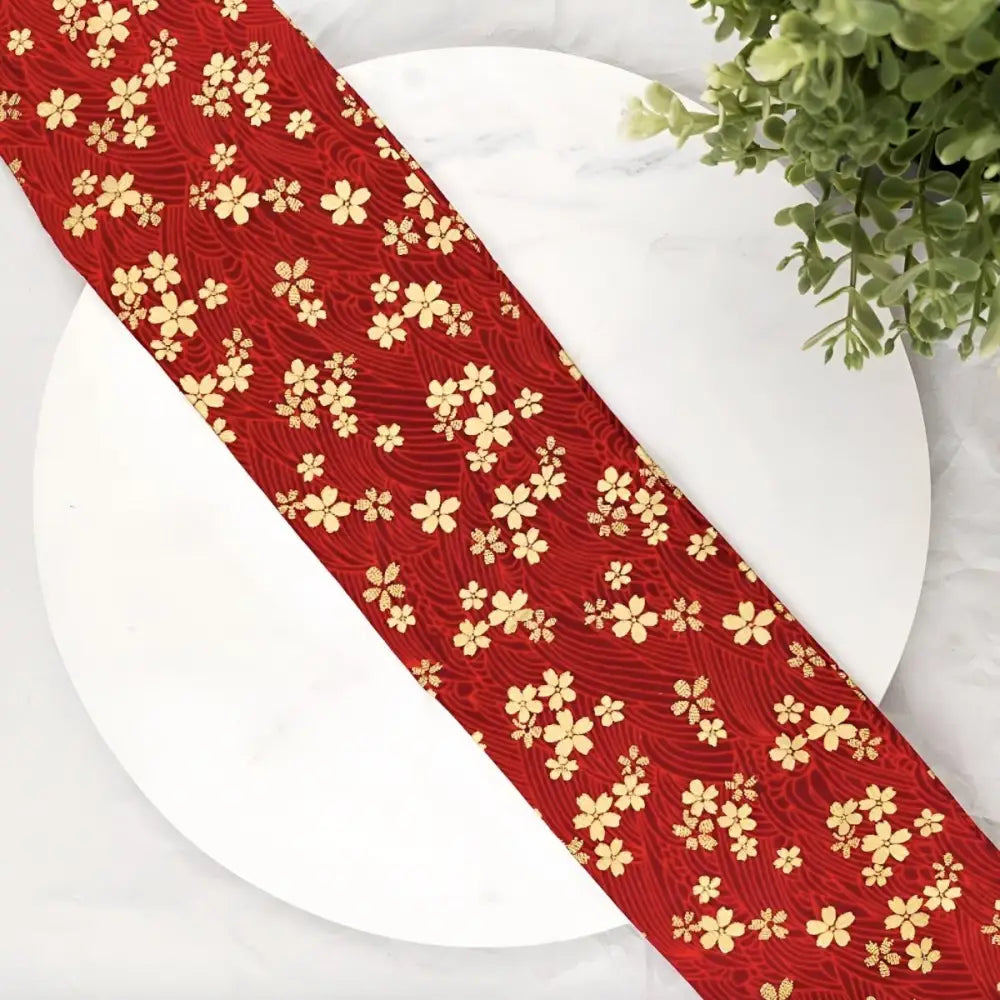 Red fabric with a floral pattern featuring a sakura flower-patterned obi belt for the Blue floral bag