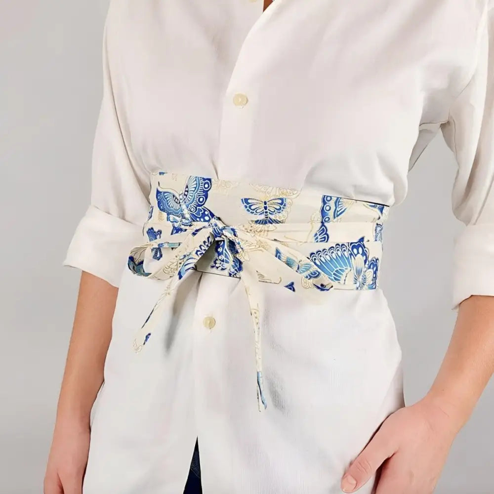 White shirt paired with a blue patterned obi belt for elegant attire fashion