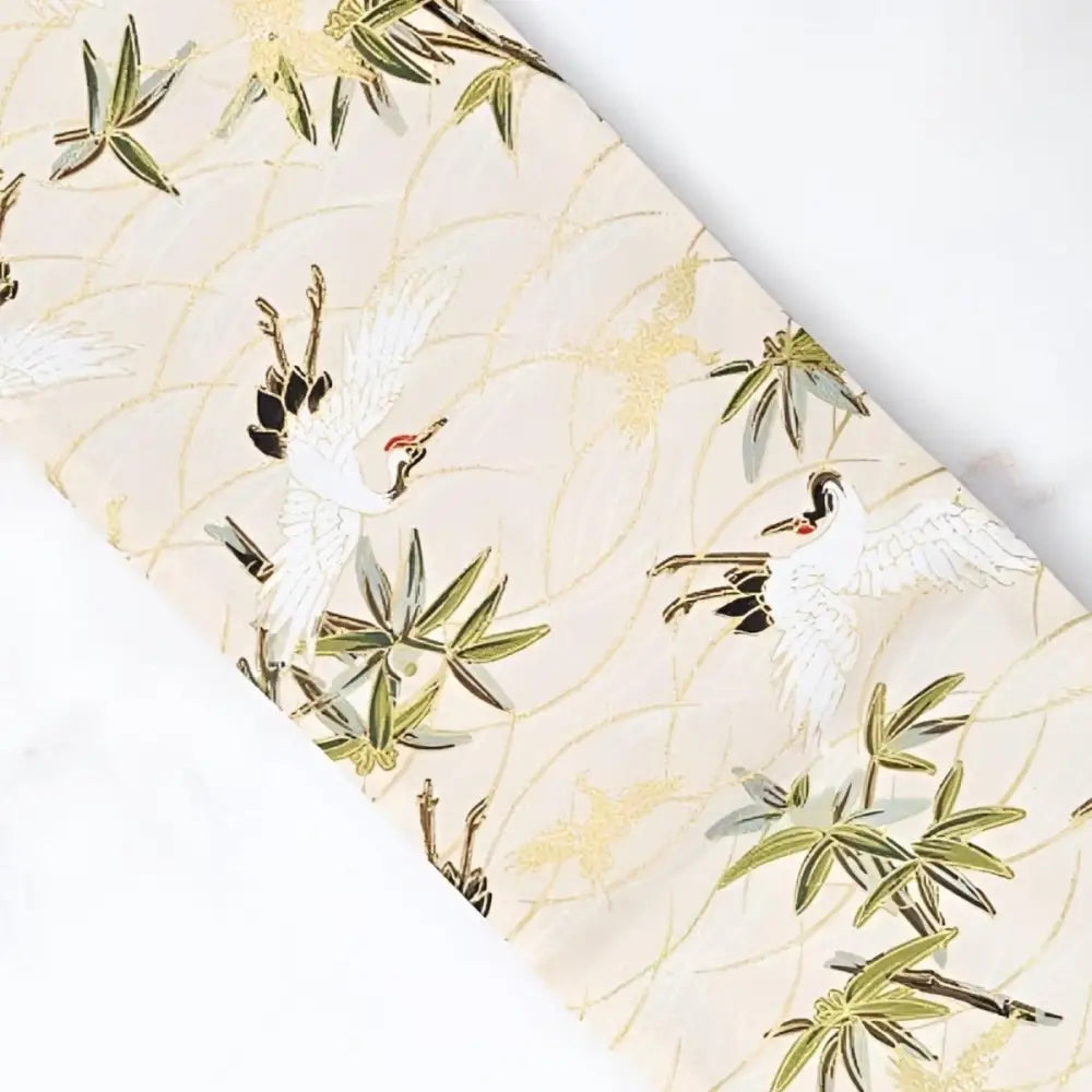 Cream crane patterned fabric featuring cranes and bamboo for elegant traditional attire