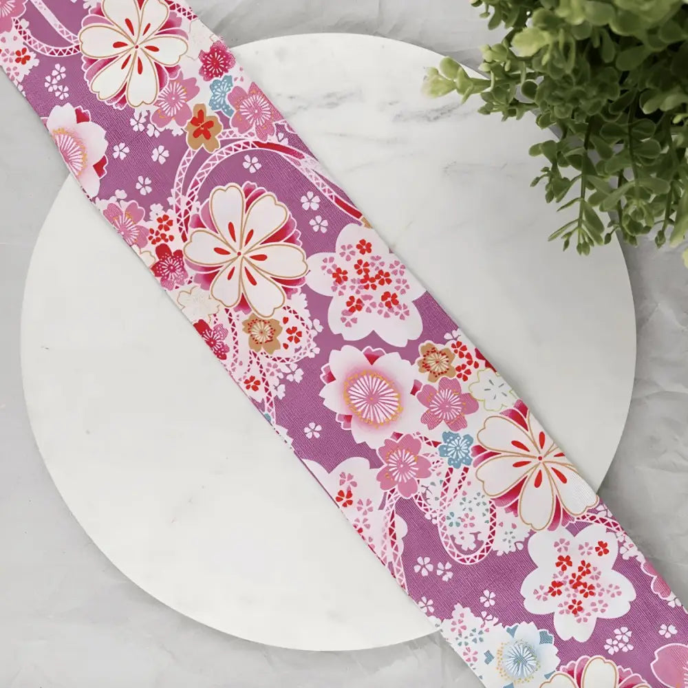 Floral patterned purple ribbon on luggage tag and Obi belt for elegant accessories
