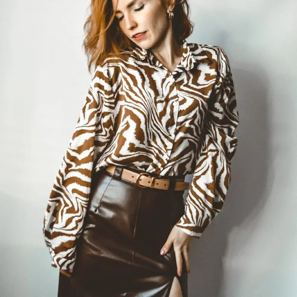 Woman wearing zebra-print blouse and leather skirt in Women’s Casual Outfit with Ribbed Turtleneck and Corduroy Pants
