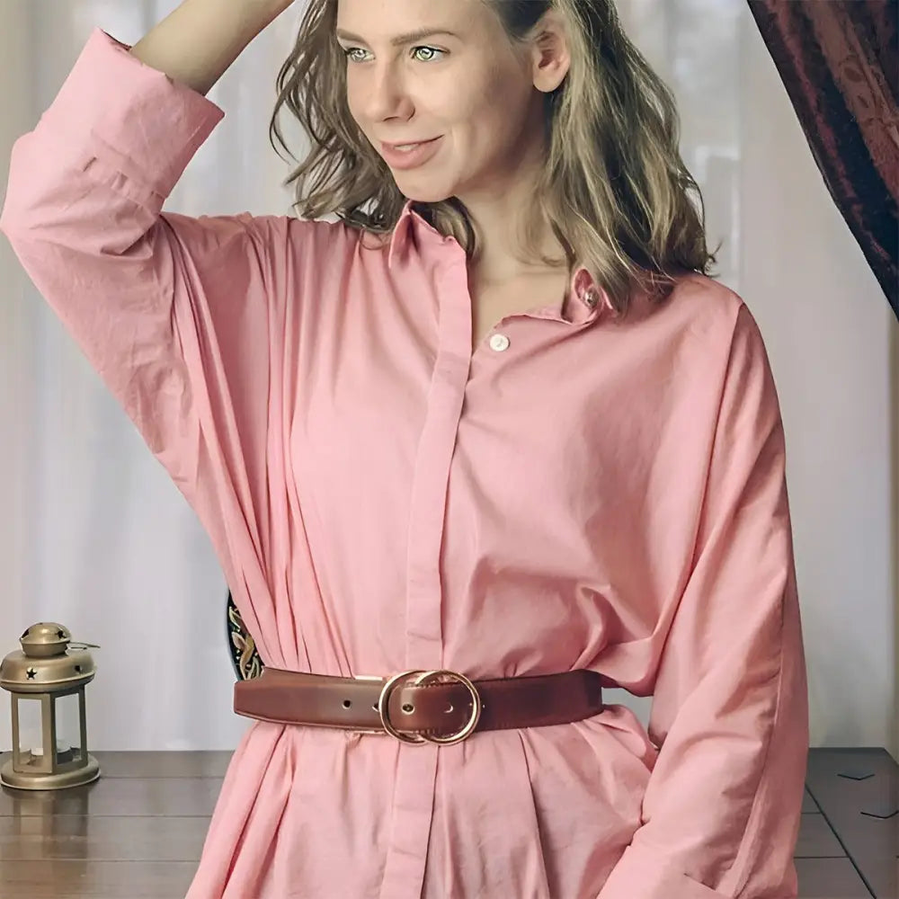 Pink collared shirt dress with brown belt.