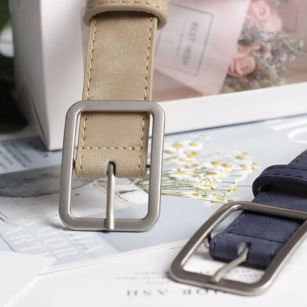 Two leather belts with silver metal buckles displayed for Assorted Leather Belts product