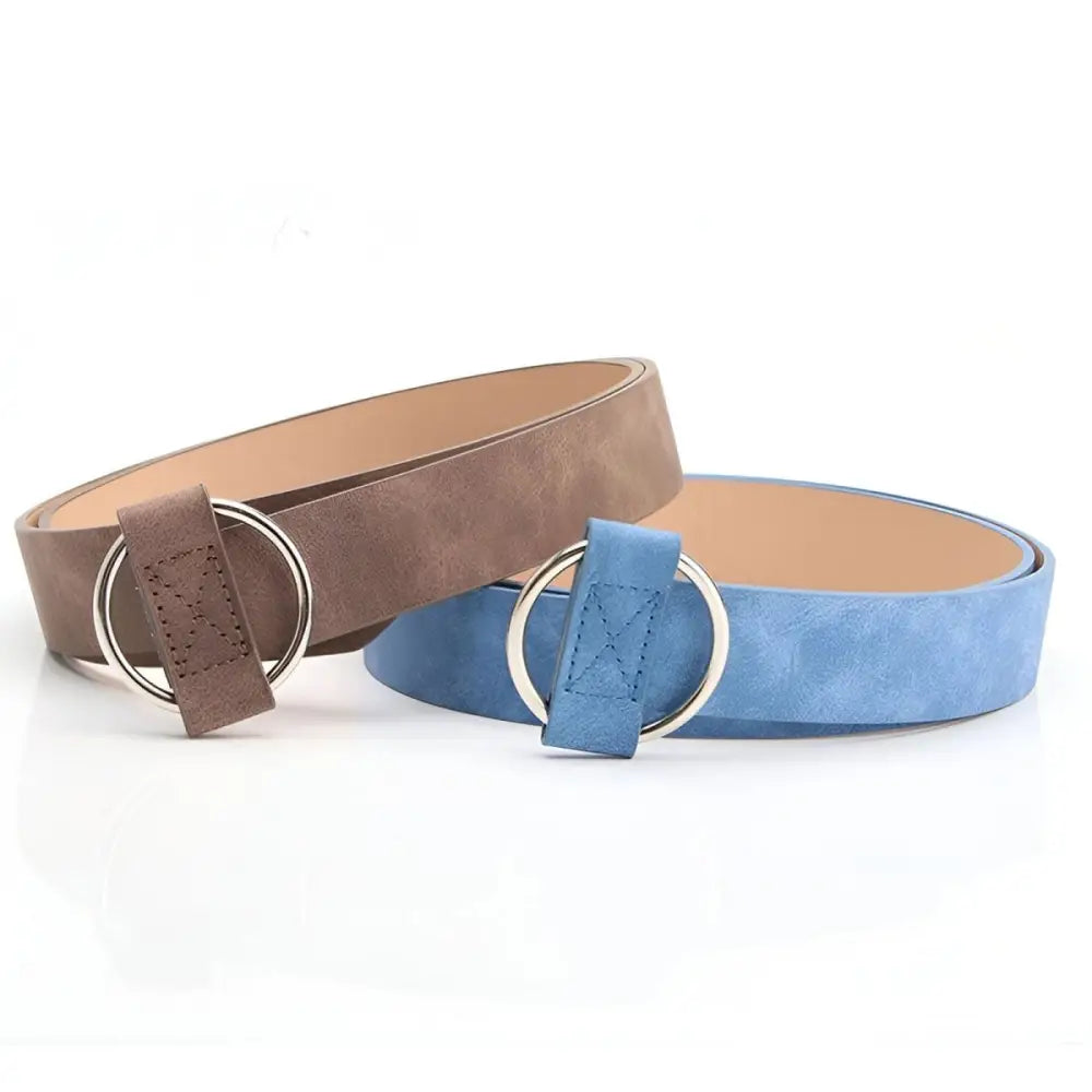 Two suede belts with ring buckles in taupe and brown colors featuring silver and circular buckles