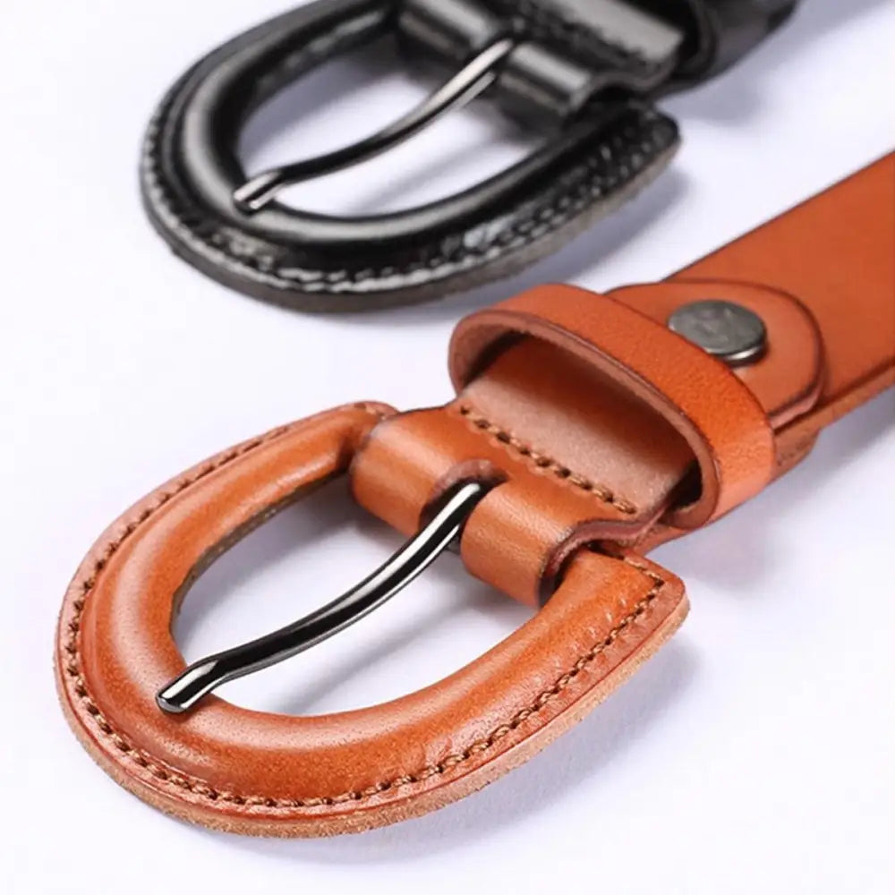 Leather belts with metal buckles featuring circular cutouts and decorative perforations for mia belt style
