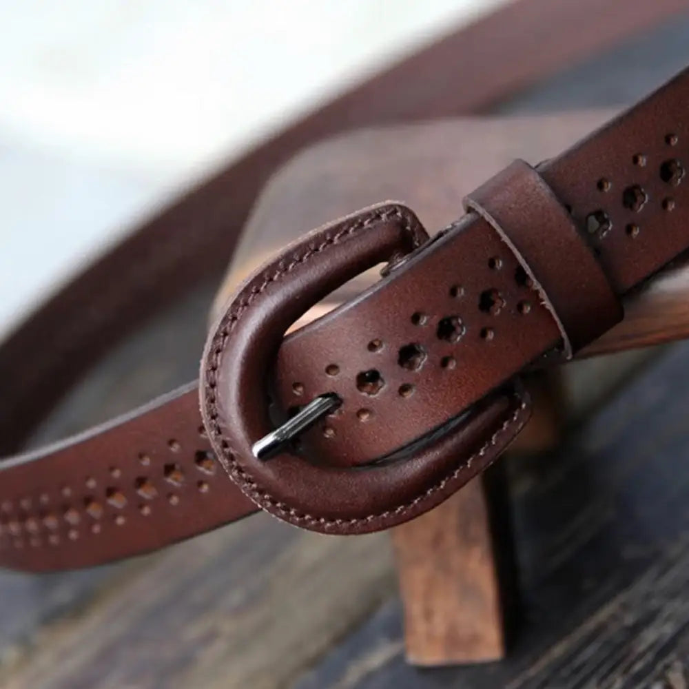 Mia Belt with circular cutouts and decorative perforations on brown leather strap