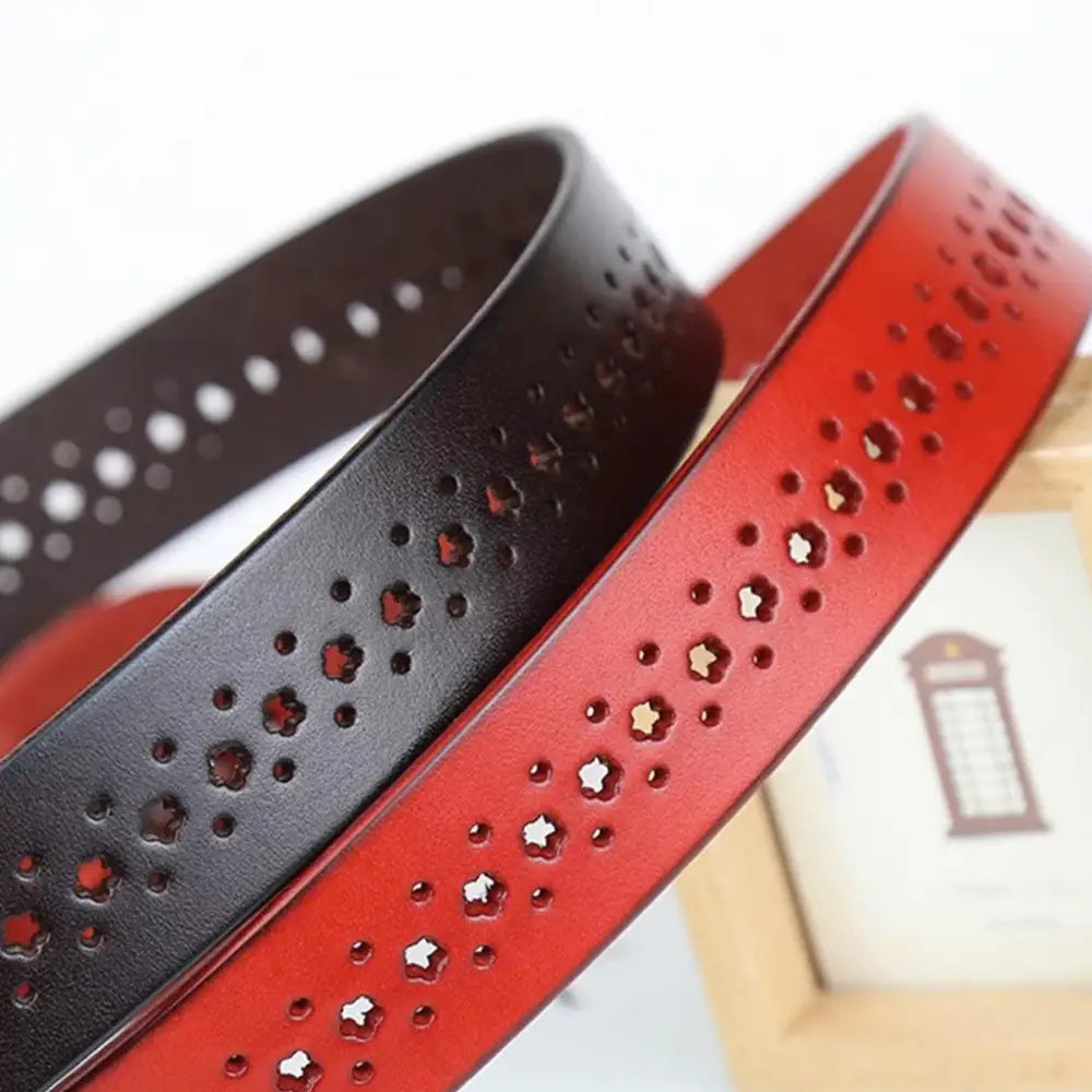 Mia Belt featuring red and black leather with star-shaped cutouts and decorative perforations