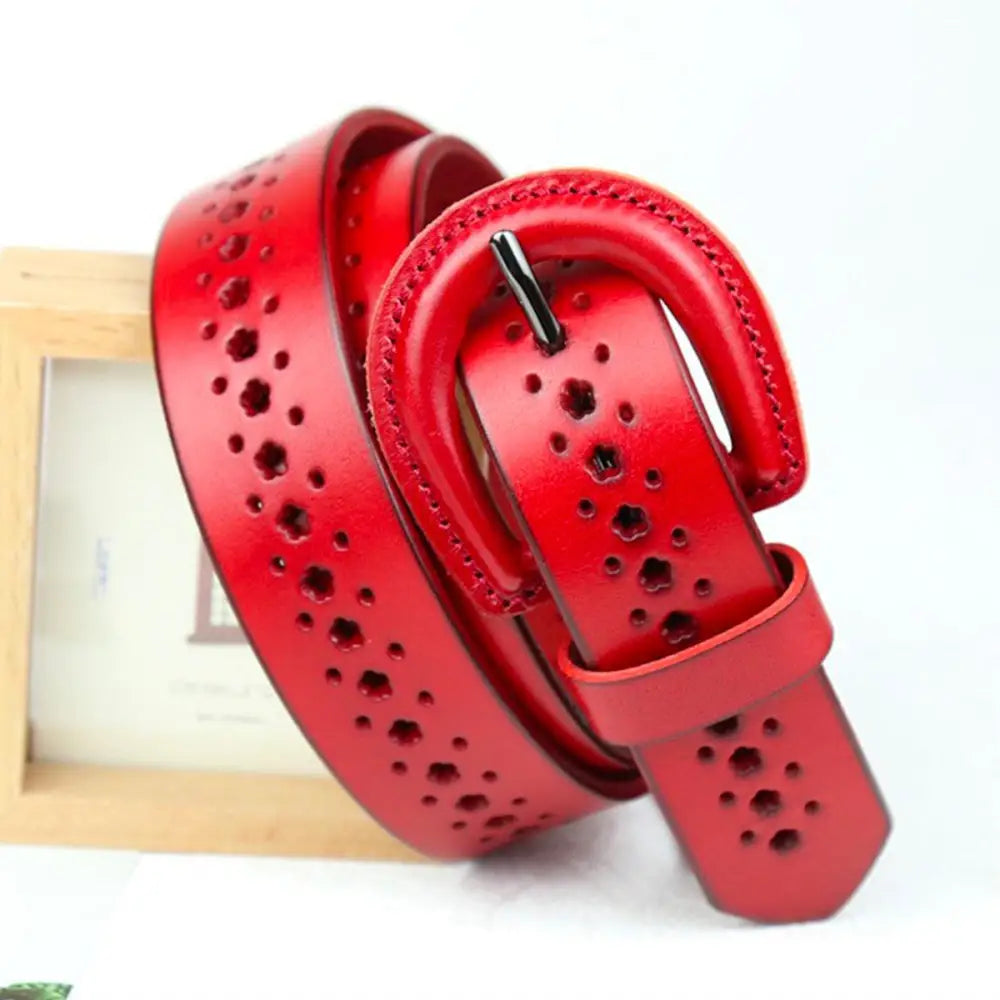 Red leather Mia Belt with circular cutouts and decorative perforations for stylish fashion