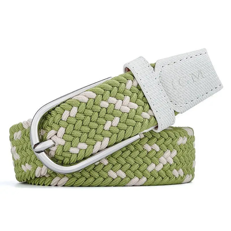 Braided green and white elastic belt with silver buckle on a woman’s waist