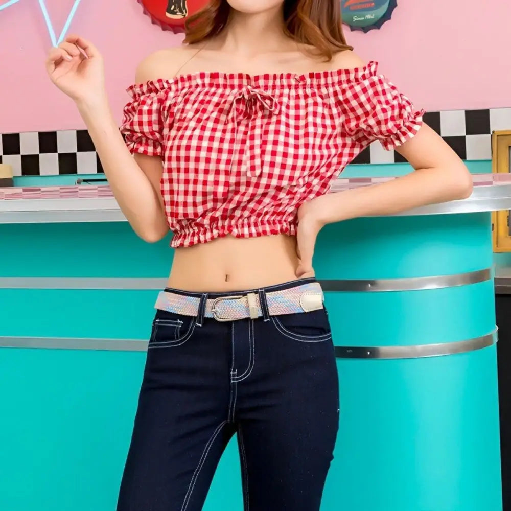 Red and white checkered crop top paired with a stylish braided belt accessory