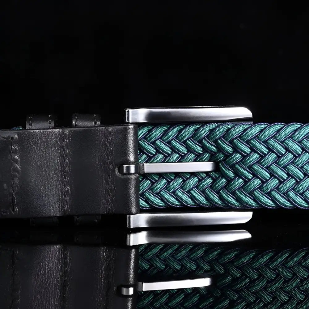 Green braided elastic belt with silver buckle and leather accents offering stylish comfort