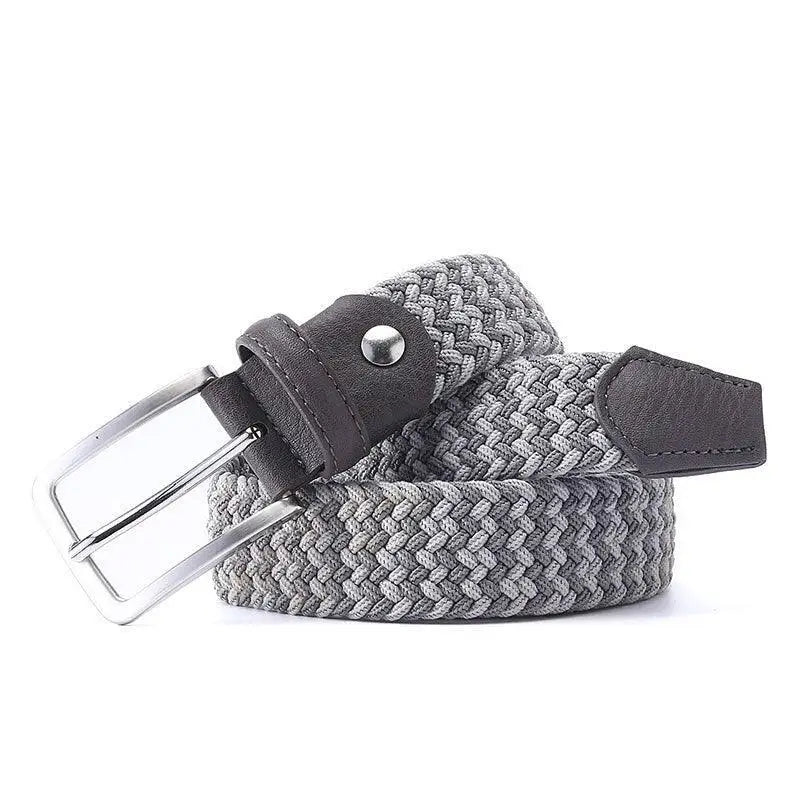 Assorted braided elastic belts with leather accents and silver buckles for stylish attire
