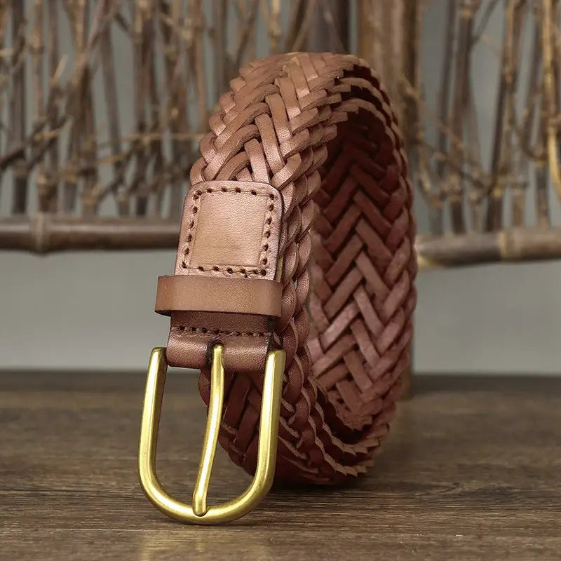 Assorted braided brown leather belts with brass and gold buckles displayed for sale