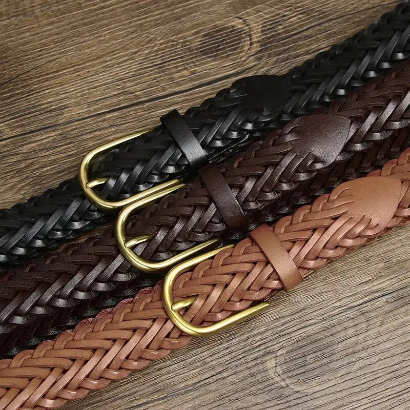 Assorted braided leather belts with brass and gold buckles displayed for stylish wear
