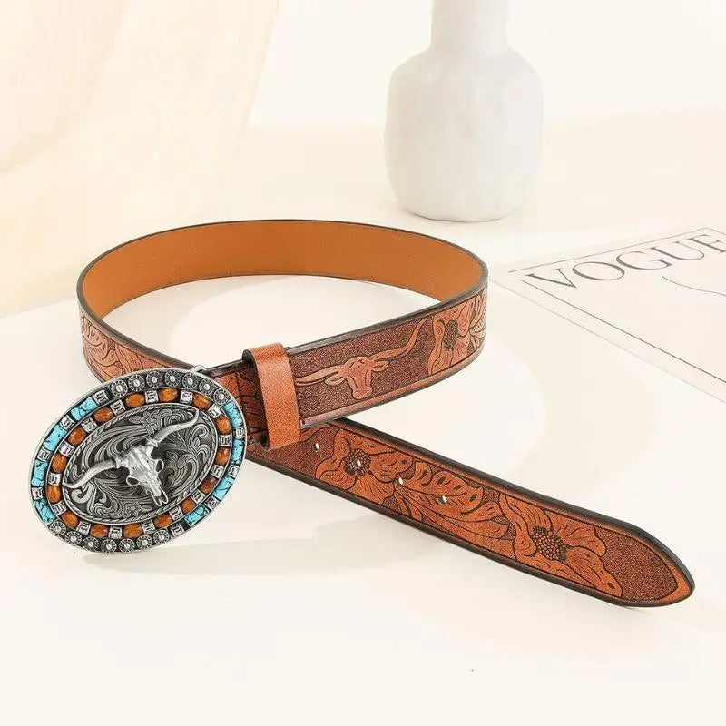 Brown leather belt featuring a steer skull buckle for western style fashion