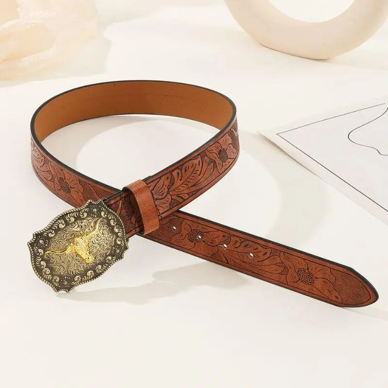 Brown leather belt featuring an ornate bull-shaped buckle for stylish wear