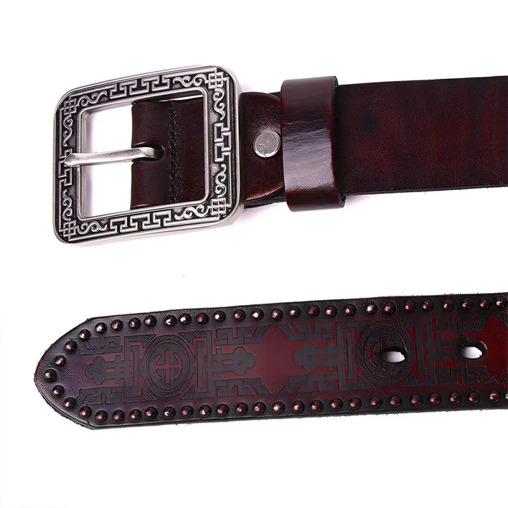 Maroon leather belt with decorative silver embossed buckle and finished end
