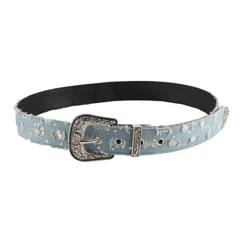 Distressed denim belt with ornate silver decorative buckle for ripped jeans style