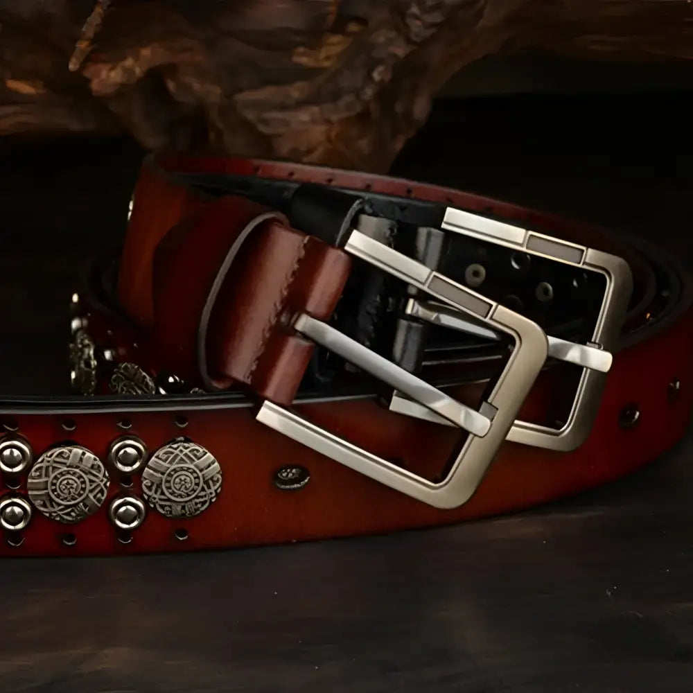 Ciradyl belt featuring studded brown and black leather with a silver buckle for style