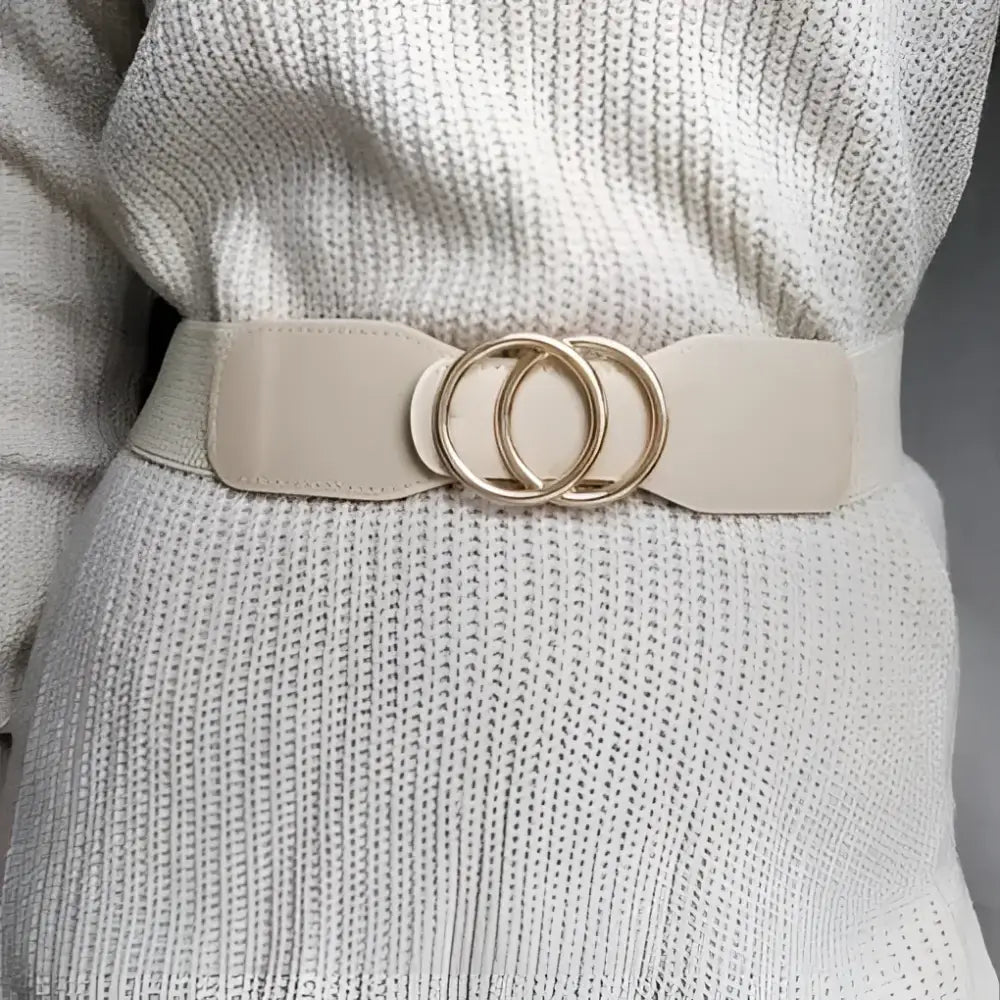 Beige elastic belt with gold interlocking circles on Cream Ribbed Dress with Black Belt