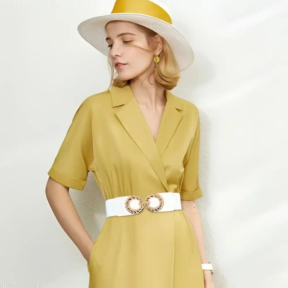 Woman in yellow dress wearing a white belt with gold double-ring buckle
