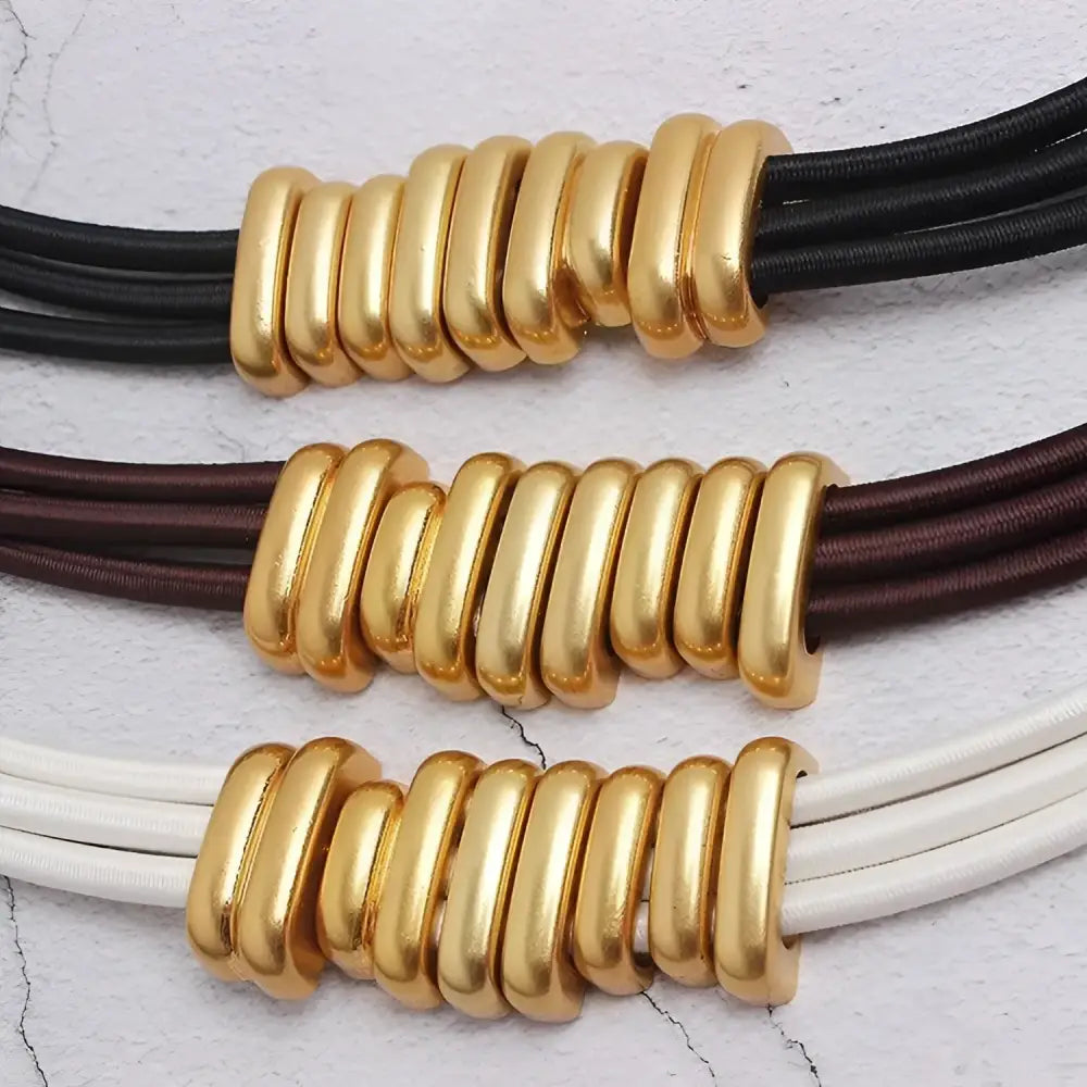 Necklaces with gold-colored tube beads complementing a trendy women’s Elegant White Blazer with Madona Belt