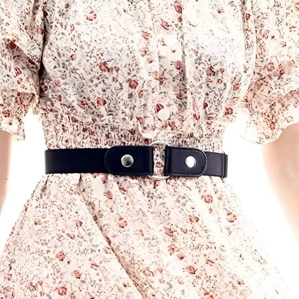 Elegant floral dress with a black belt and gold ring detail for stylish occasions
