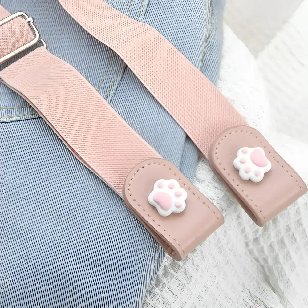 Pink elastic girl’s Eulalie belt with cartoon button and cat paw closures
