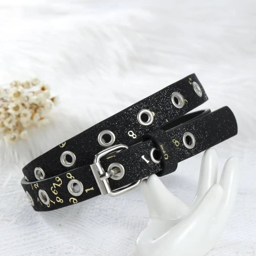 Black glittery belt with grommets and a silver buckle from Glittery Belts collection