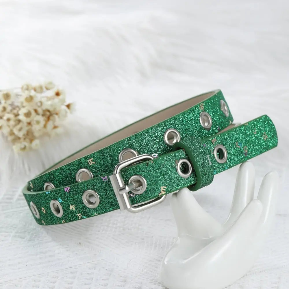 Green glittery belt with grommets and silver buckle in a stylish accessory