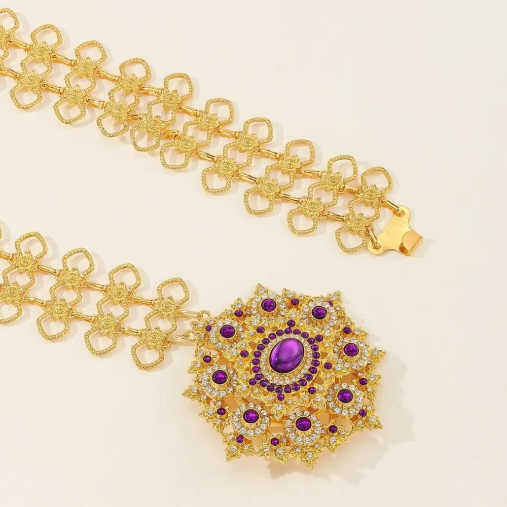 Gold belt with jeweled buckle featuring rhinestone accents for an elegant accessories look
