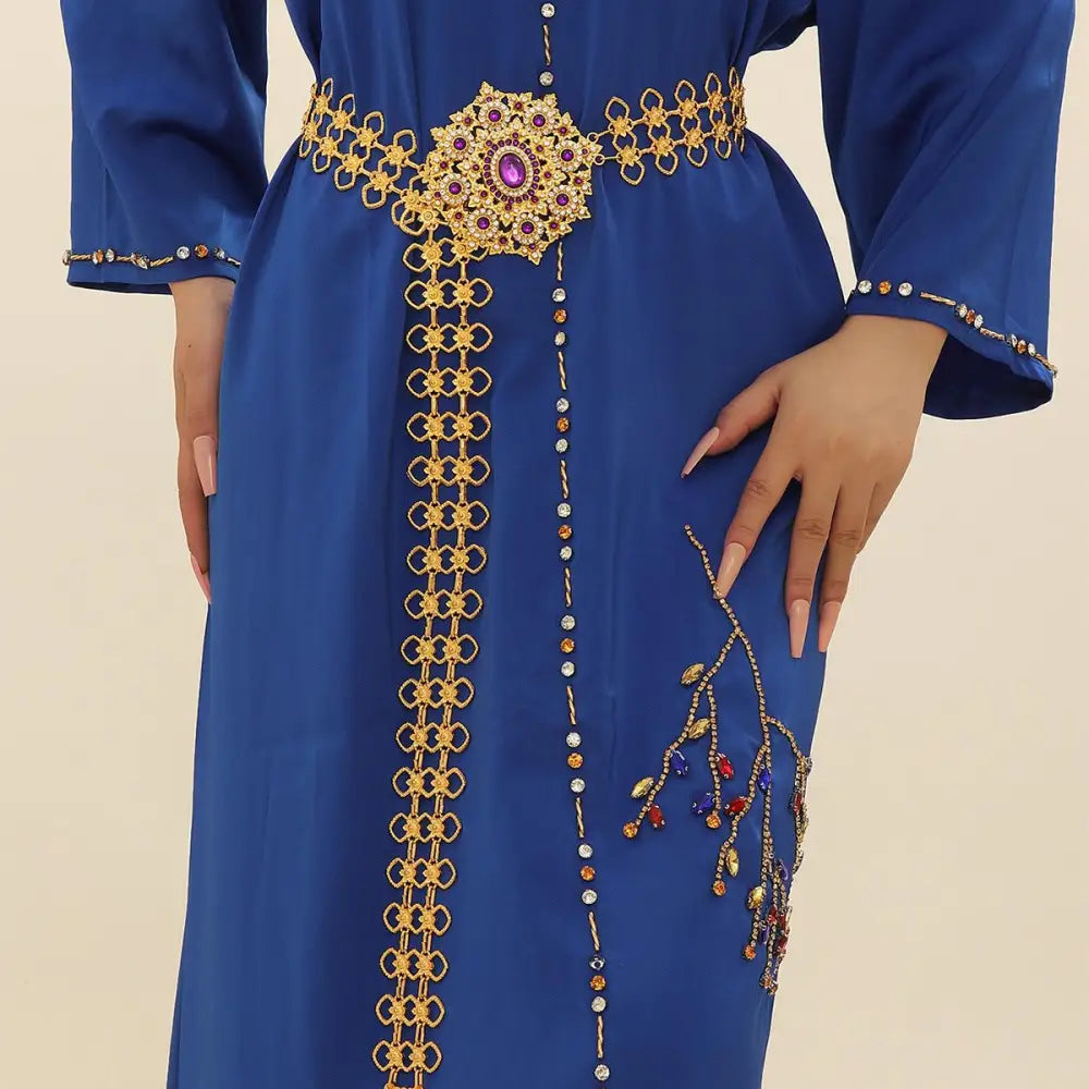 Blue dress with gold and jewel embellishments displayed in a gold belt with jeweled buckle