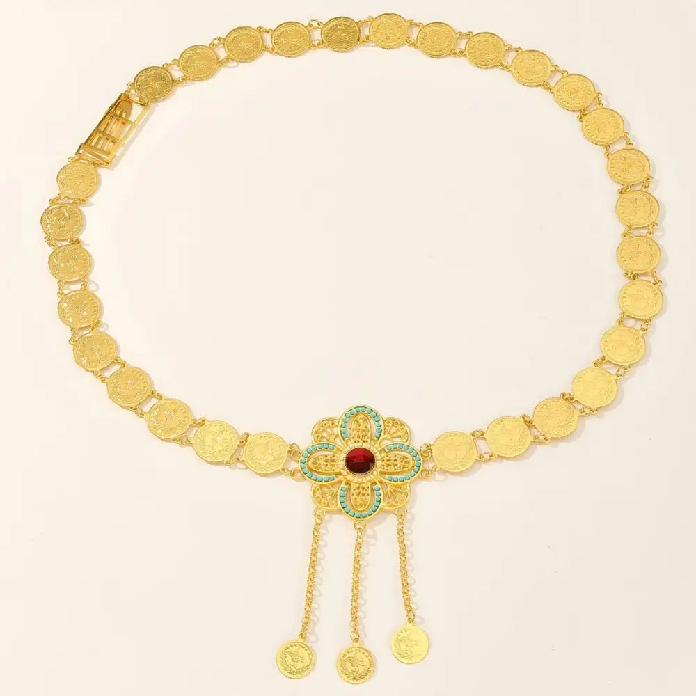 Gold coin belt featuring an intricate floral centerpiece for elegant fashion style