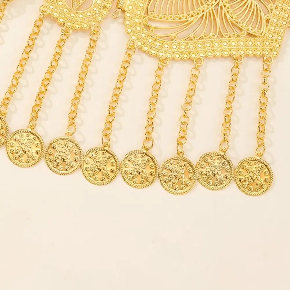 Gold-toned coin-dangling necklace featured on Moroccan belt with ornate filigree buckle