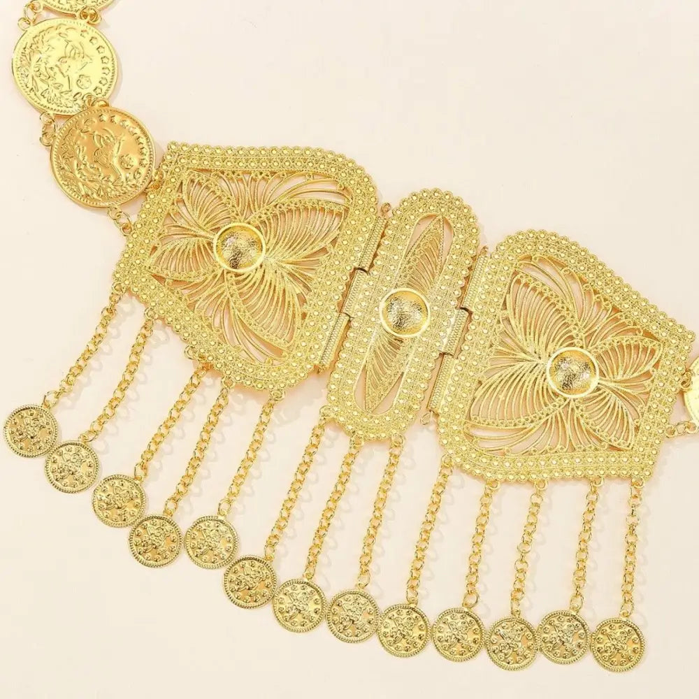 Ornate gold coin and filigree buckle on Moroccan belt for elegant fashion accessory