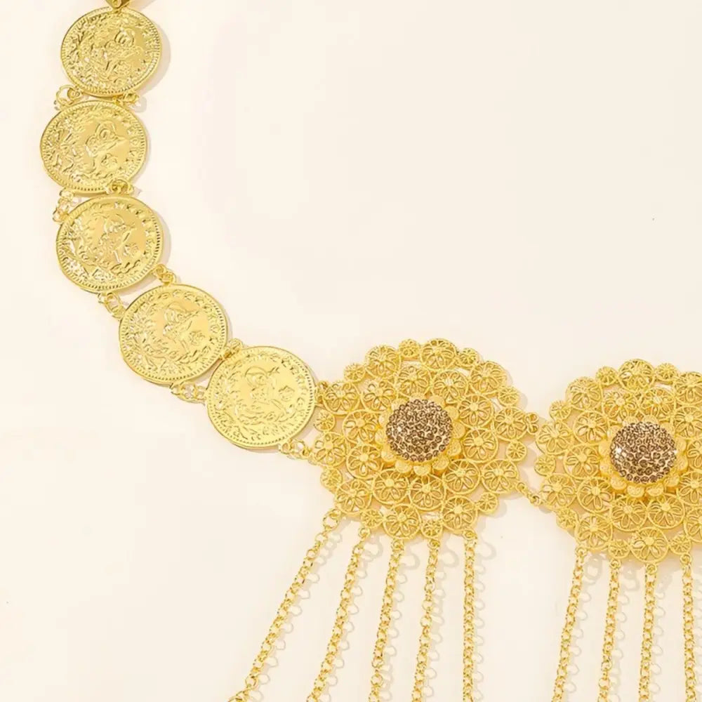 Gold coin and intricate filigree floral medallion belt display for elegant accessory appeal