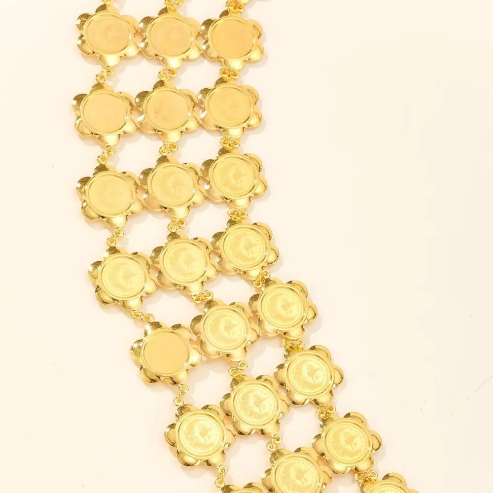 Gold-toned floral medallion chain featured in Moroccan belt for elegant style