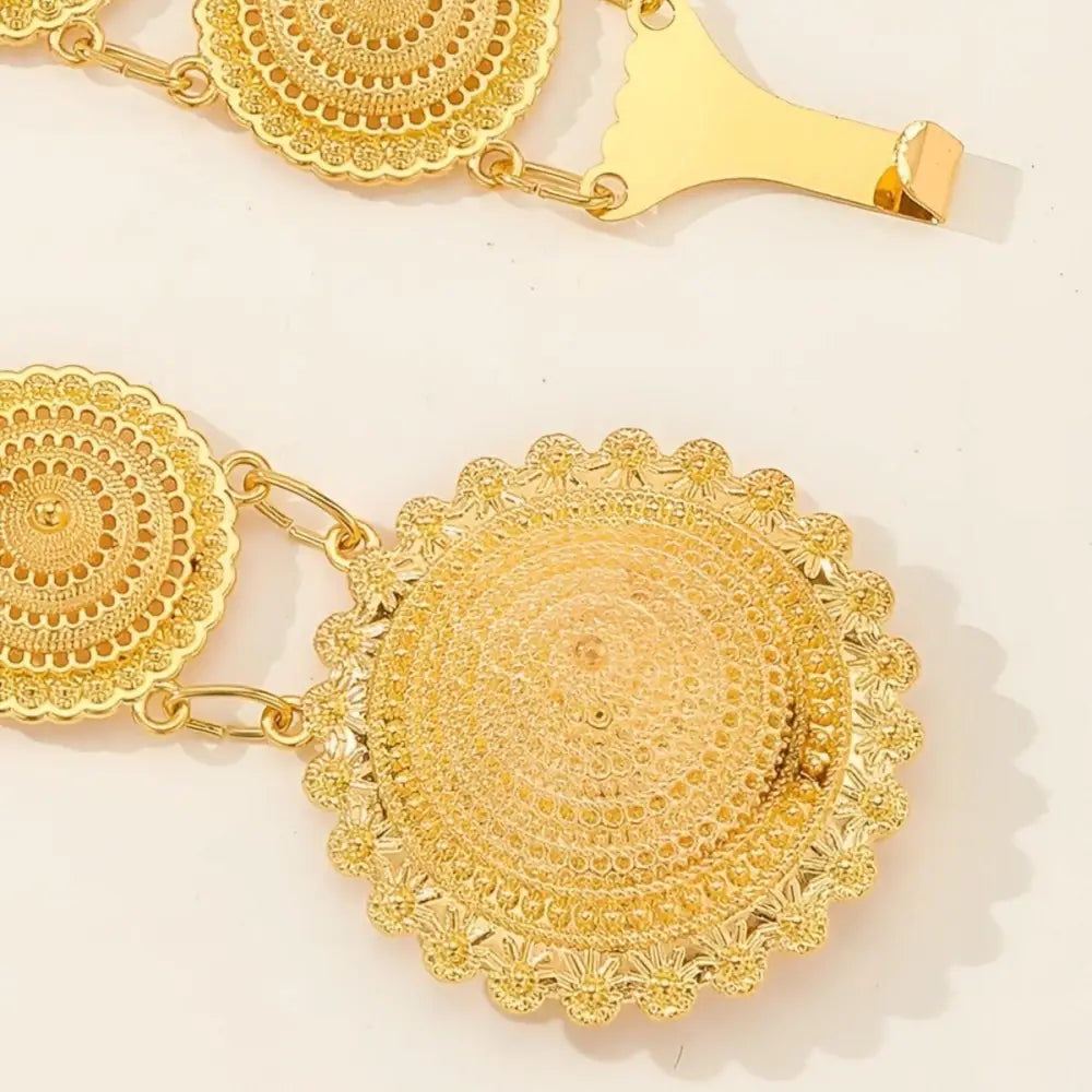 Gold-toned decorative moroccan belt featuring circular links and intricate filigree medallion details