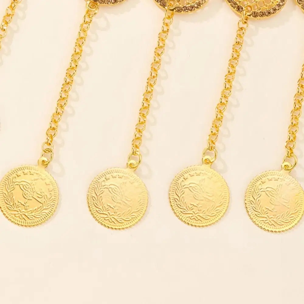Gold coin pendants with chains on a Moroccan belt featuring dangling medallions